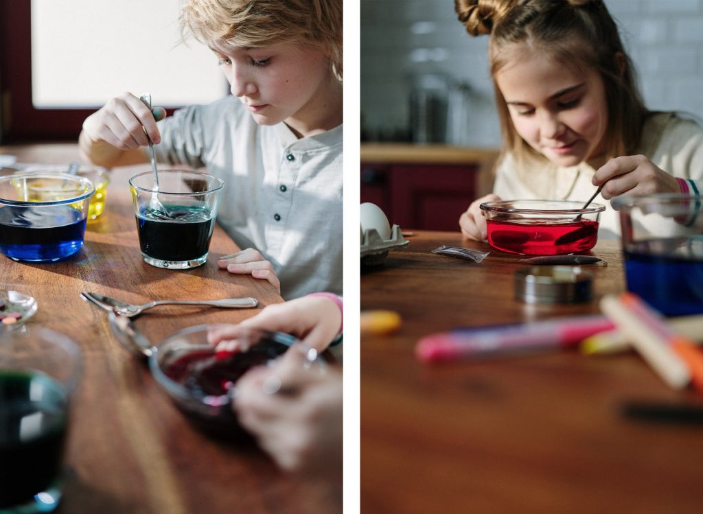 Boy And Girl Mixing Water With Colored Dye