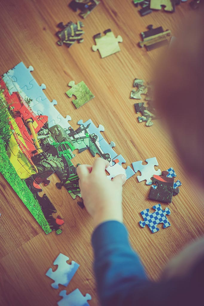 Child's Hand Doing Puzzle