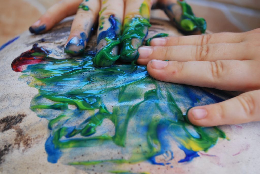 Child Hands Doing Messy Finger Painting