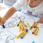 Creative Child Scribbling With Crayon
