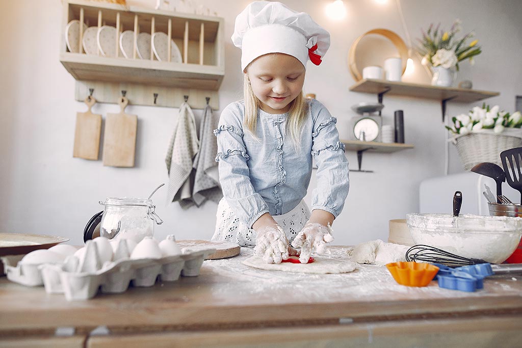 Young Girl In White Chef Hat Prepping Cookie Dough