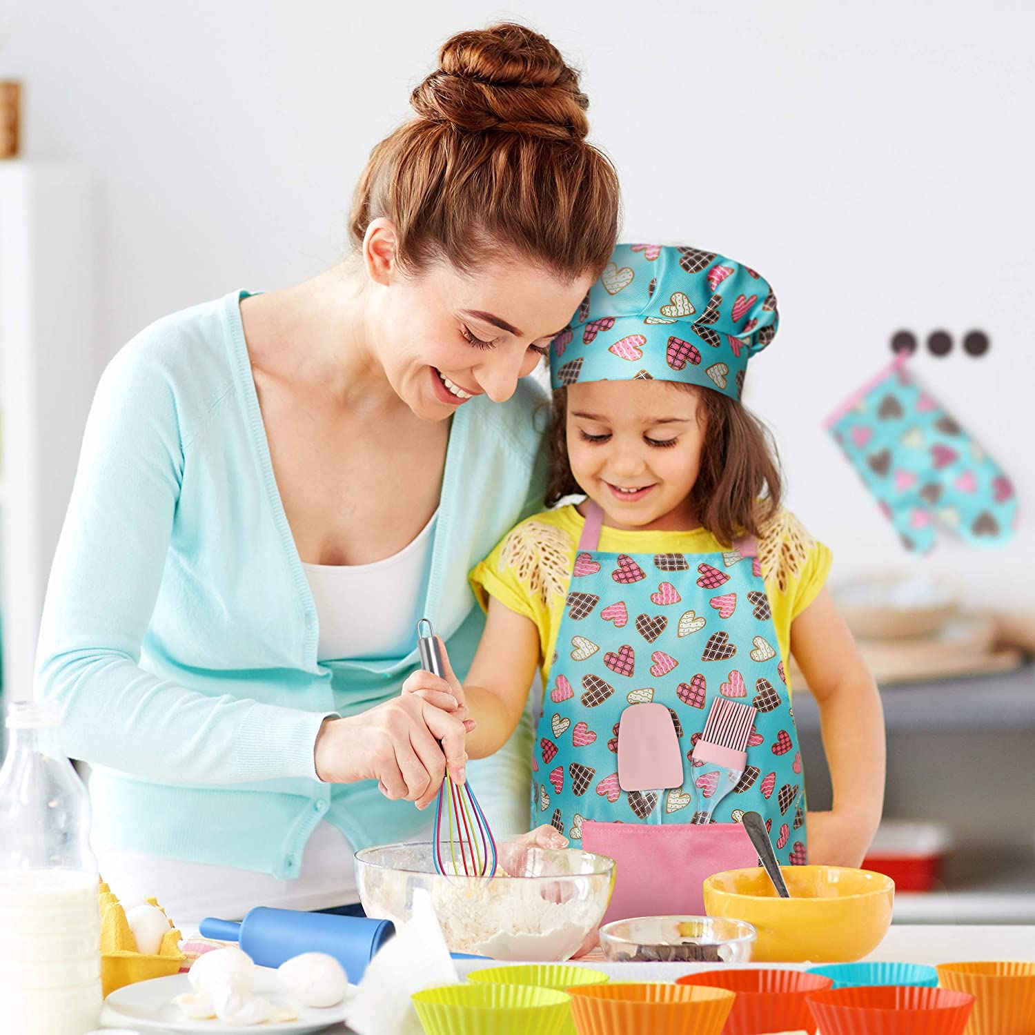 Young Girl Wearing RiseBrite Pink Hearts Apron Set Baking With Mother