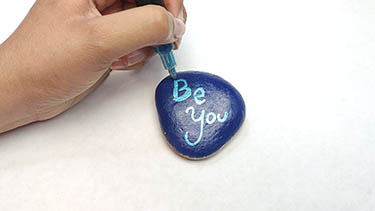 Kindness Rock Painting Tutorial Step 8: Add Inspirational Text With An Acrylic Paint Marker