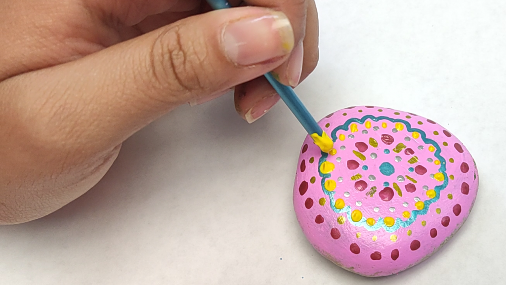 Mandala Rock Painting Tutorial Step 18: Make Dots Using The Tip Of A Brush Handle Inside The Flower Pattern